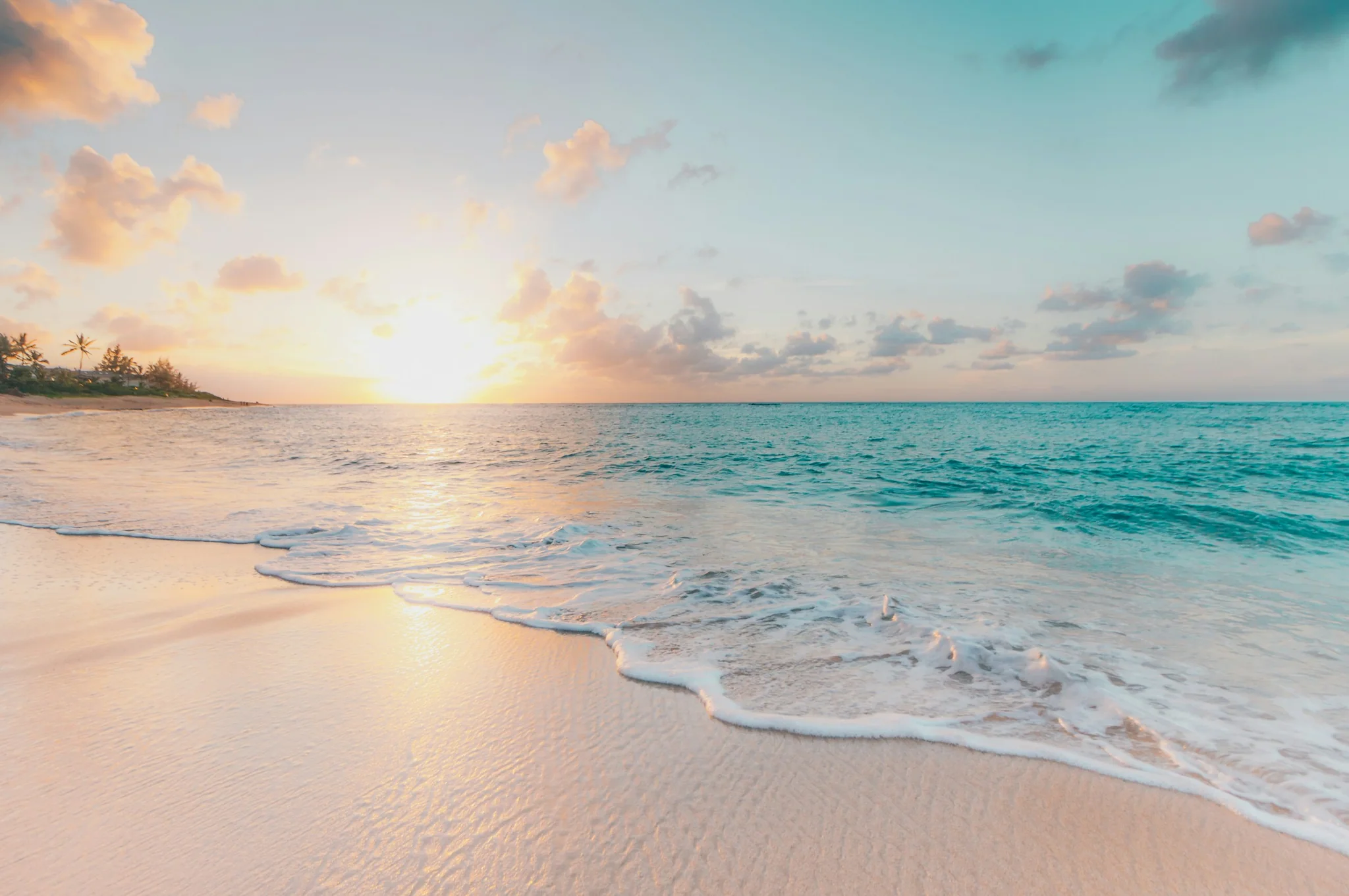 Turquoise sea meeting a bright hazy horizon